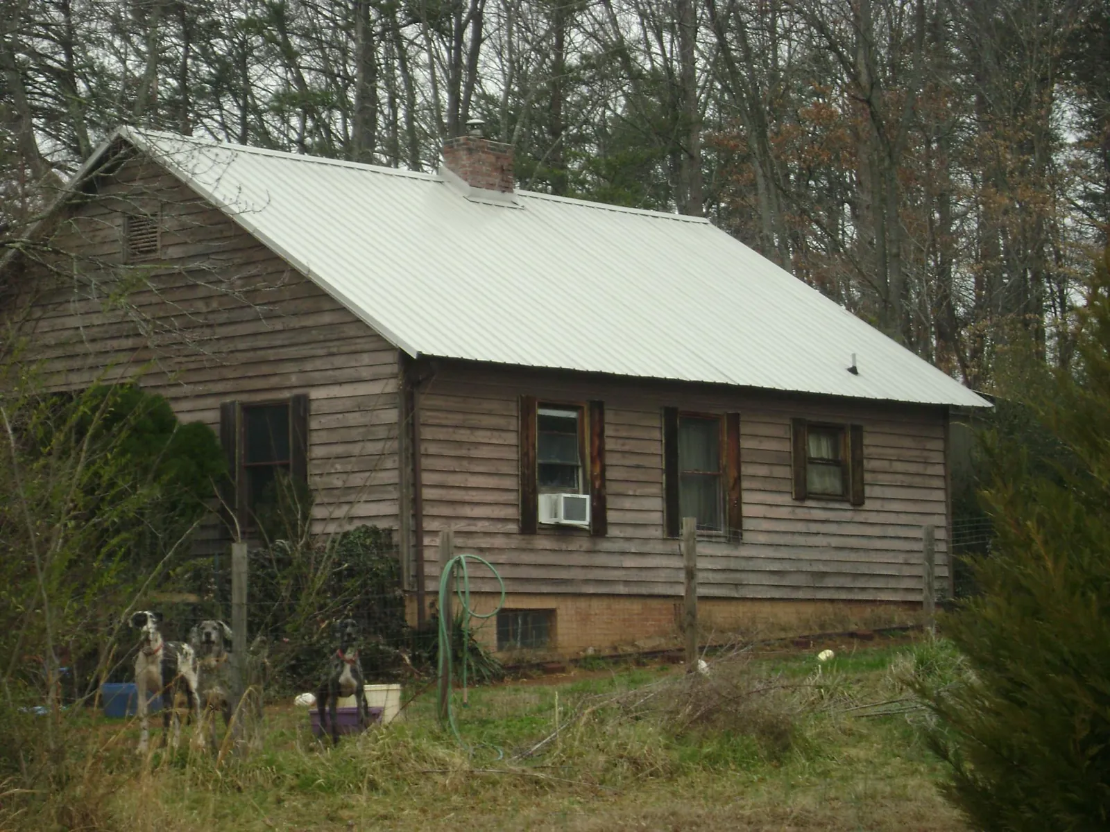 White metal roof on an old wood sided farmhouse, from a Metal Roof Installation job in Millbrook